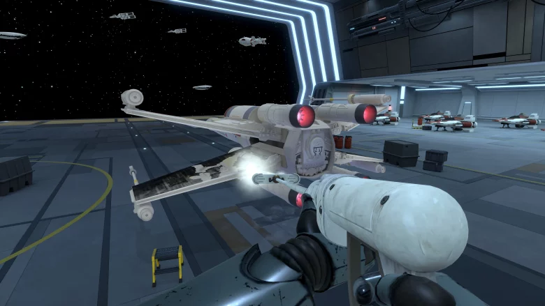 First-person view from a pilot in a white spacefighter, aiming a forward cannon inside a futuristic hangar with ships docked along the bay.