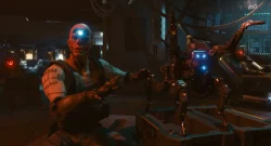 Cyborg soldier with a glowing blue eye reaches toward a blue-lit robotic arm in a dim high-tech lab setting, preparing for repair.