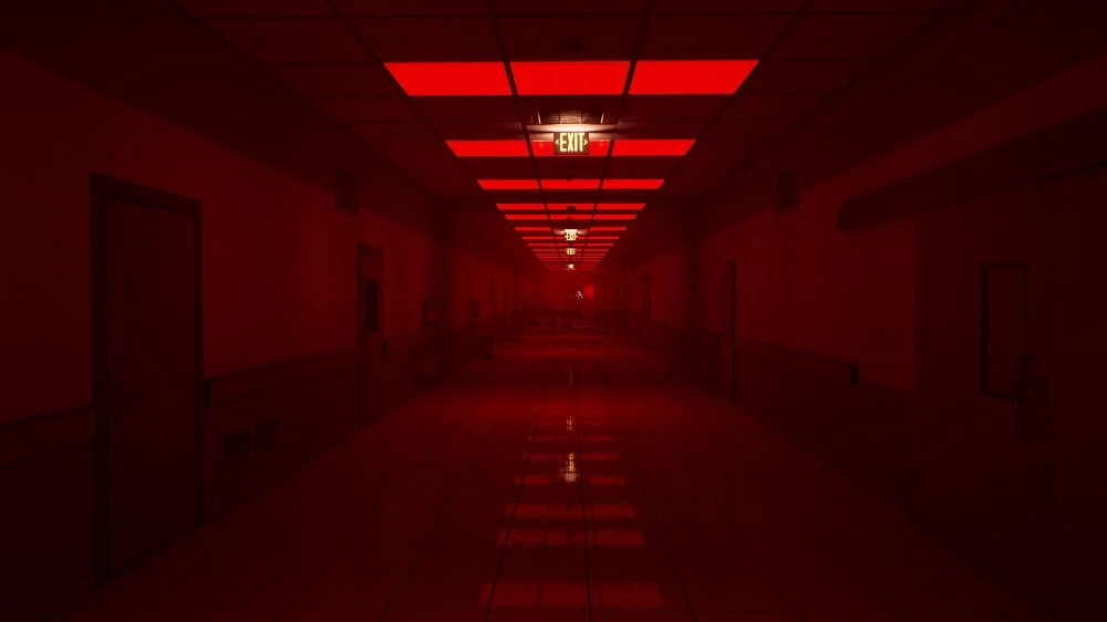 Dim hospital corridor illuminated by red emergency lights, vanishing point at far end where an exit sign glows.
