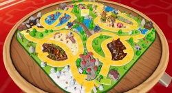 Circular game board with a bright yellow winding path, trees, water features and miniature attractions on a green base.