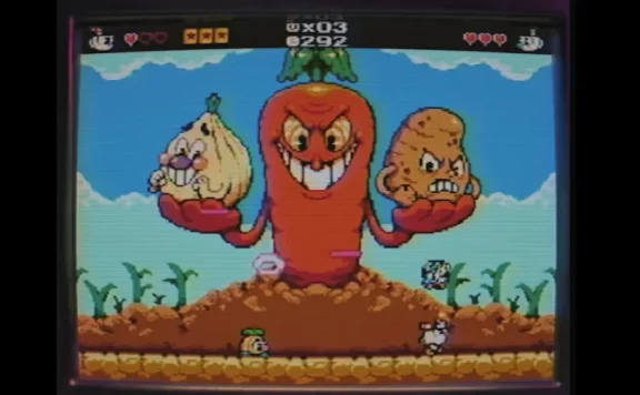 Retro video game screenshot: a giant cartoon carrot monster with a grinning face holds an onion in one hand and a potato in the other, set in a pixelated outdoor scene with a small hero at the bottom left.