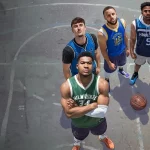 Seven basketball players in colorful jerseys stand in a circle on an outdoor court, looking up at the camera with a basketball on the ground nearby.