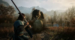 Armored warrior crouches with a drawn sword facing a large, clawed creature in a boggy swamp, snow-capped mountains in the distance.