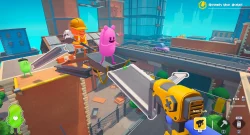 Cartoon construction site in a video game; pink blob dances on a wheelbarrow while a worker with a helmet holds a hammer, a green blob nearby.