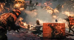 Soldiers in orange armor crouch behind sandbags as fiery explosions erupt across a snowy battlefield.