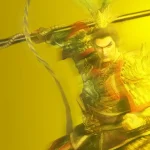 Warrior in ornate armor swinging a long weapon, mid-action pose, intense expression, golden-toned scene