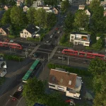 Aerial view of a city neighborhood with a red tram on tracks crossing a busy intersection among trees and houses.